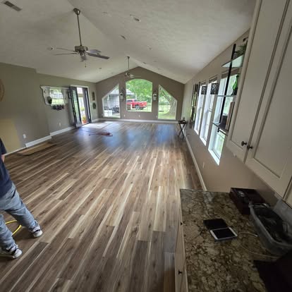 Warm wood-look flooring in a bright open-plan living space